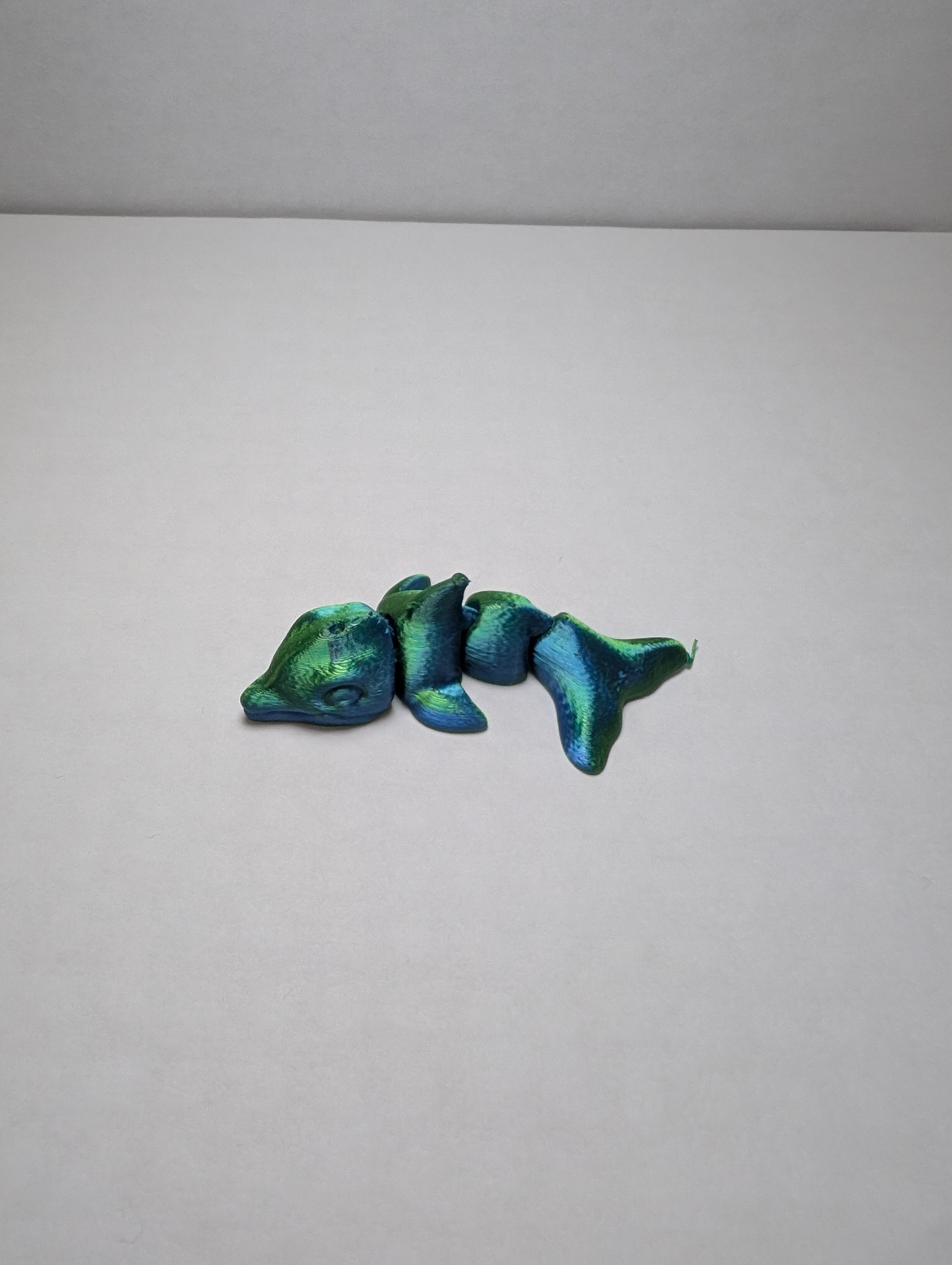 The Emerald Flexi-Dolphin – Your Desk’s New Splash of Color