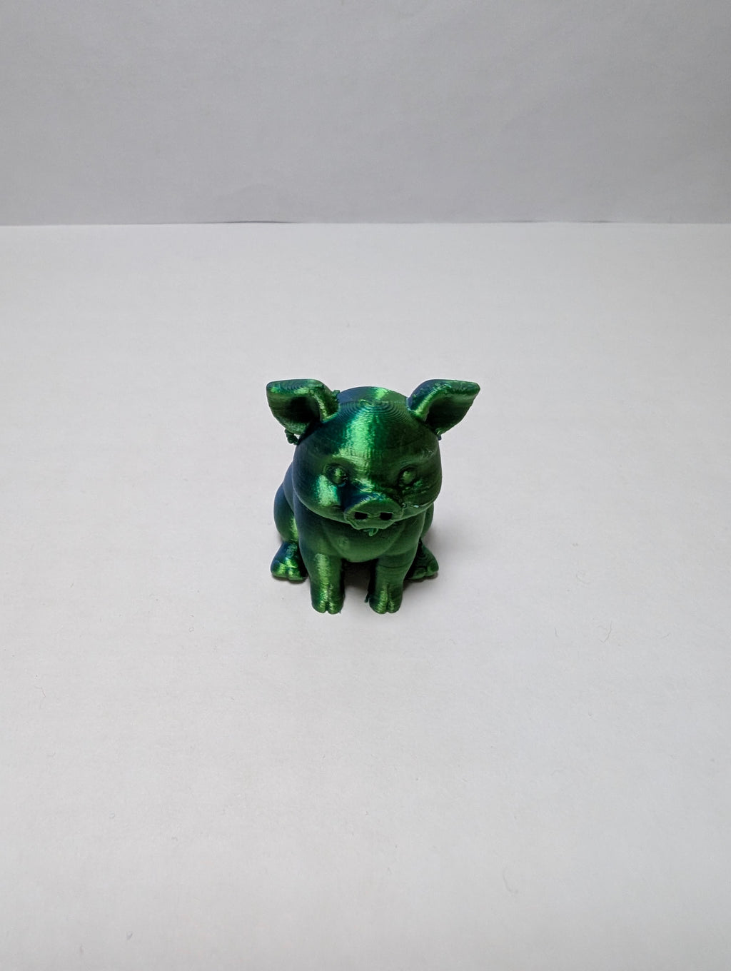 The Emerald Sitting Piglet – A Shiny Spot of Good Luck