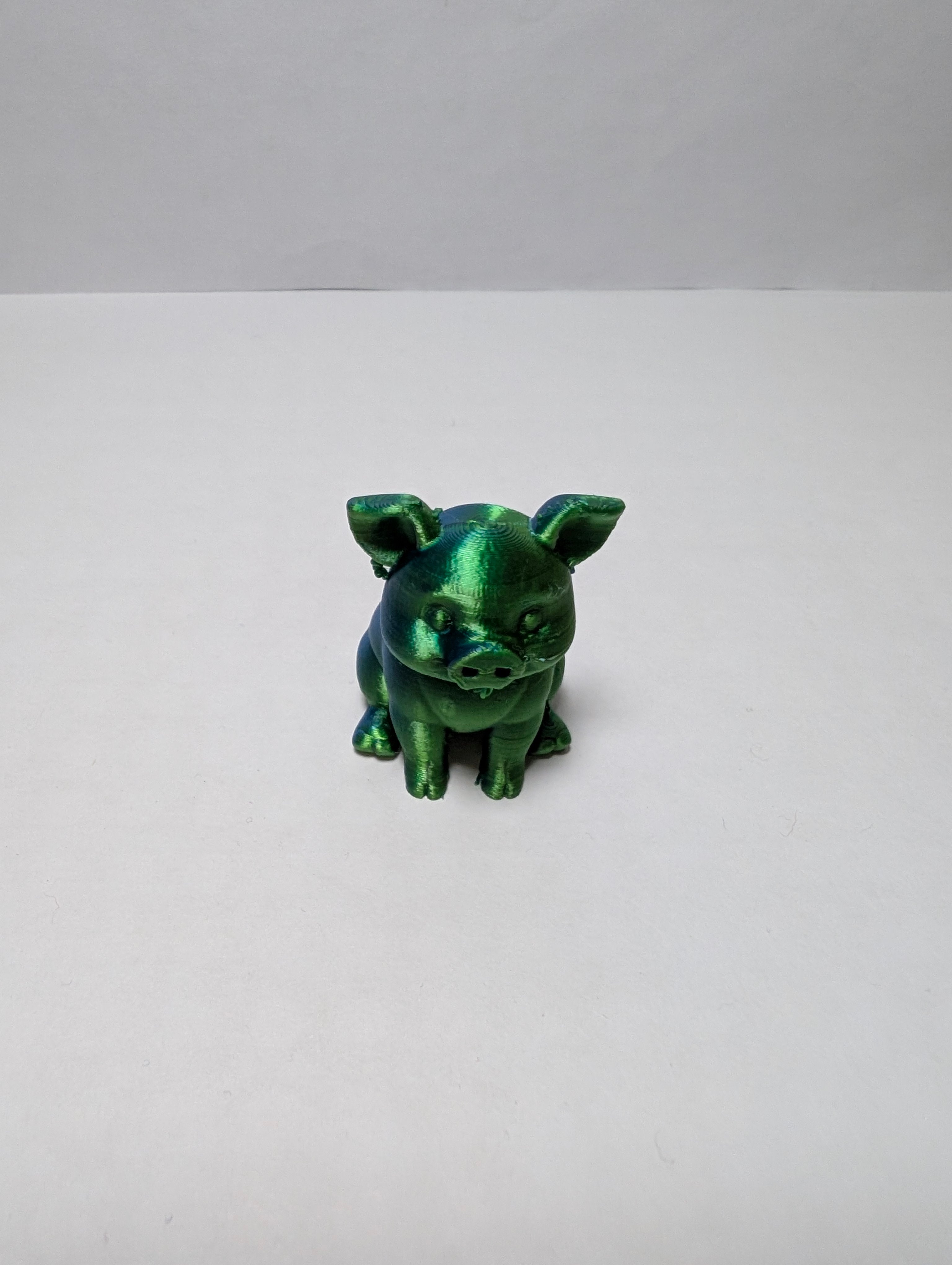 The Emerald Sitting Piglet – A Shiny Spot of Good Luck