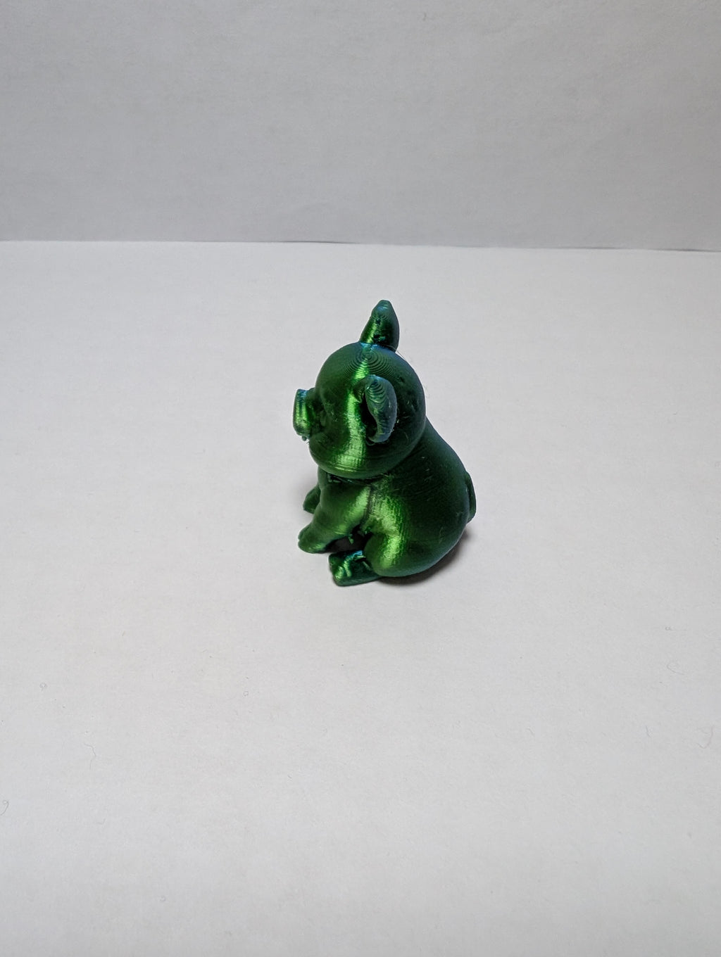 The Emerald Sitting Piglet – A Shiny Spot of Good Luck
