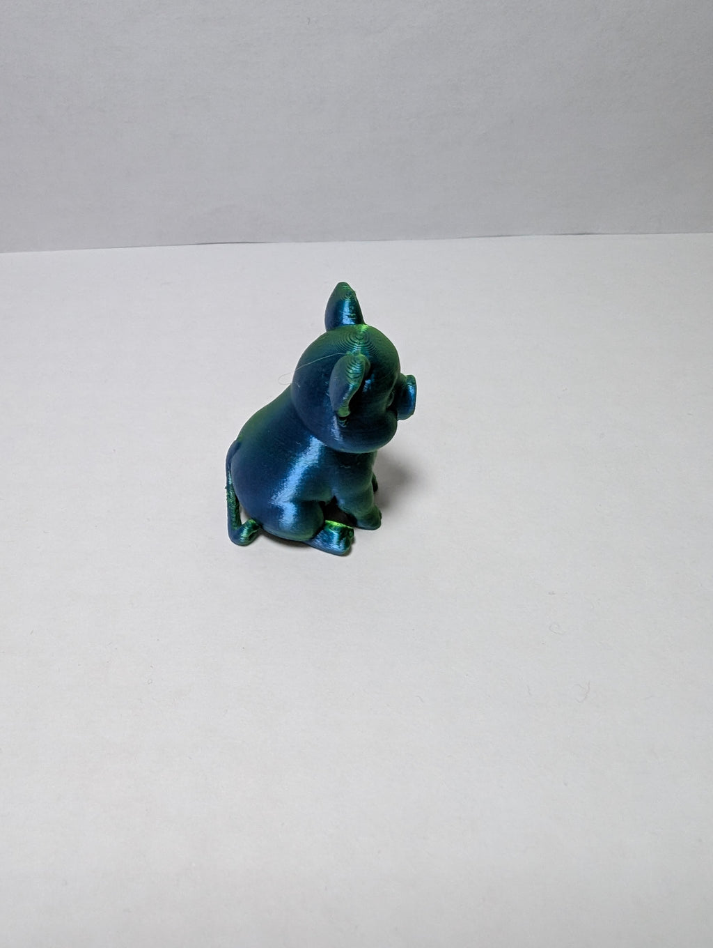 The Emerald Sitting Piglet – A Shiny Spot of Good Luck